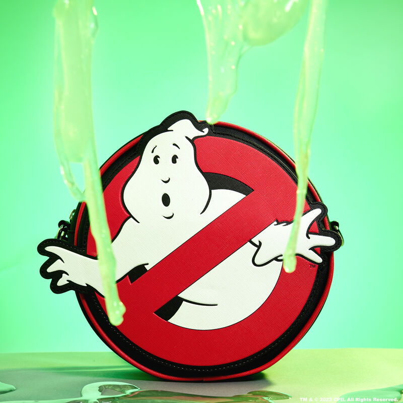 Image of the Ghostbusters Logo Glow Crossbody Bag against a green background with slime dripping down and around it 